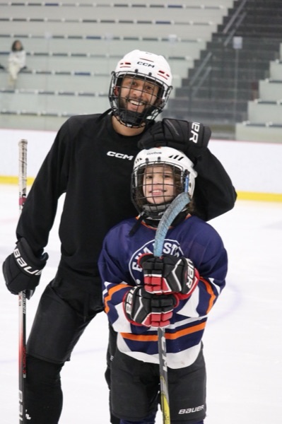My son and I on the ice posing at a club event.